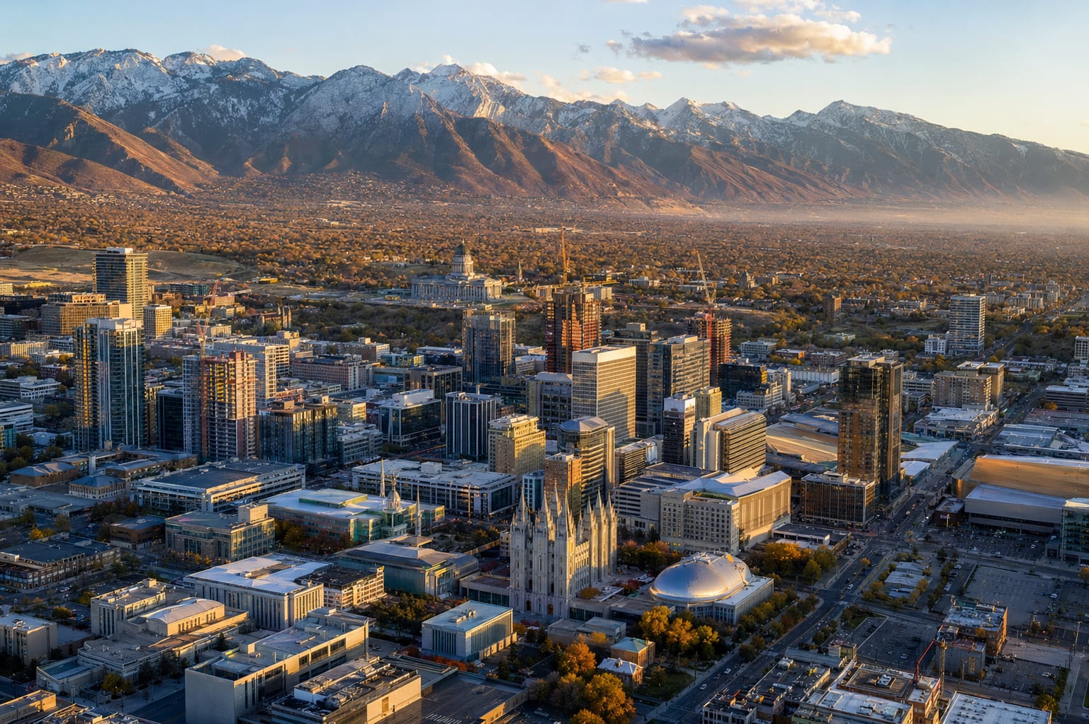Aerial view of the Salt Lake Valley with homes spread below the Wasatch Mountains.